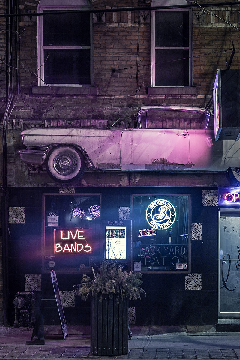 Old Car Mounted Against Side of Building Old Car Mounted Against Side of Building